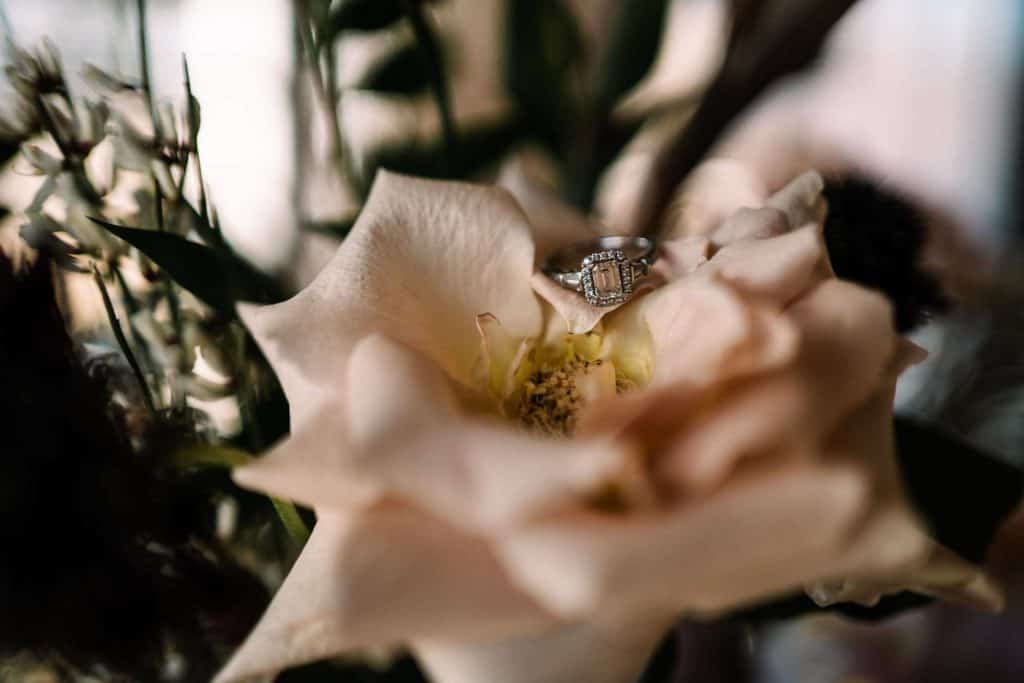 wedding day details: wedding ring and flowers