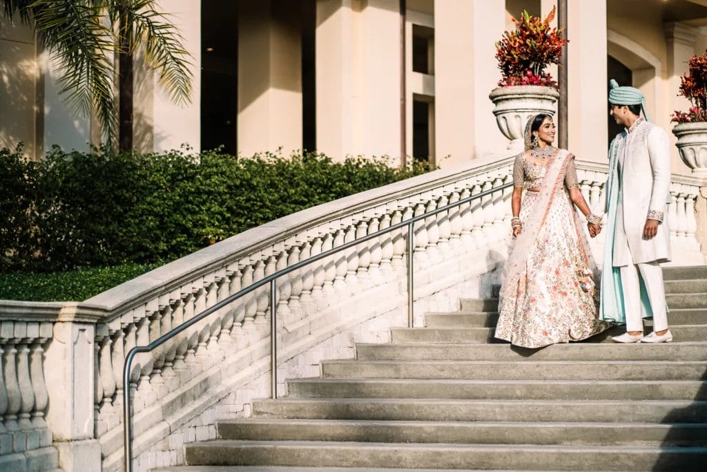 Bride and groom walking the stairs at the Gaylord Palms