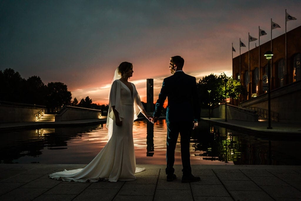 A couple at sunset elopement by the water from Orlando wedding Photographer Roy Serafin. 