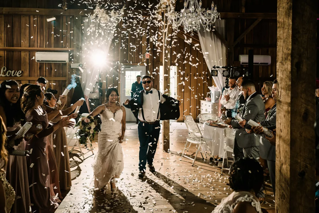 Couple dancing, surrounded by falling confetti at their wedding, a symbol of joy and happiness