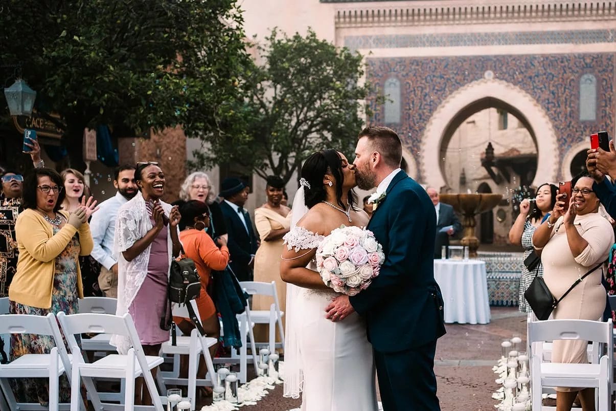 A couple kissing during thier ceremony at Morocco in Epcot. 