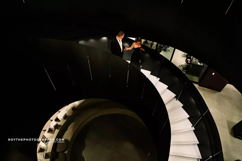 A couple walking down the stairway at the Winter park events center. 