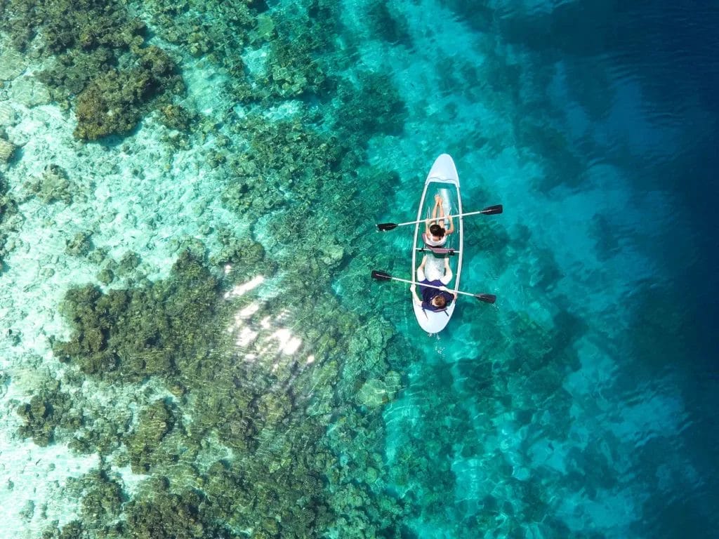 A boat in the water of the coral reefs