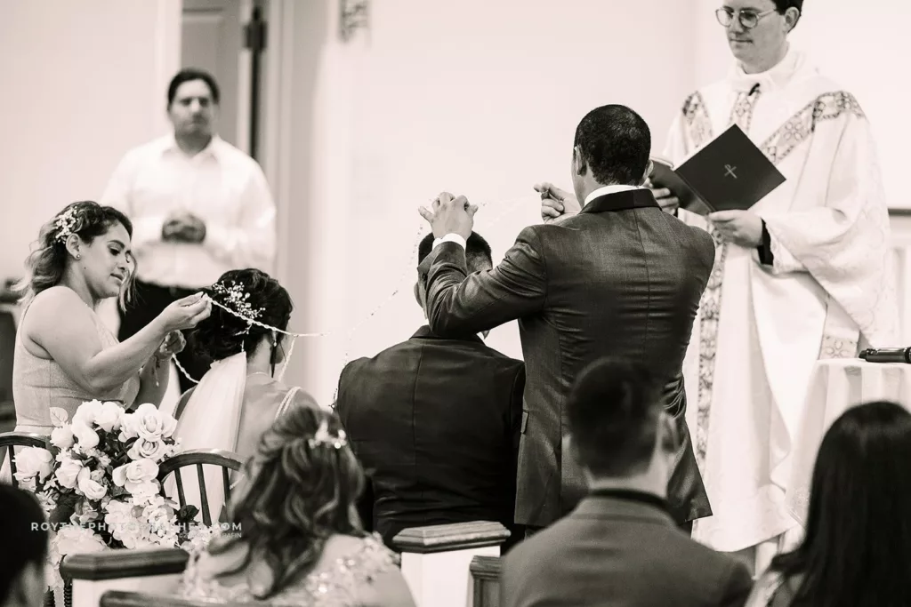 El Lazo, madrinas and padrinos place the wedding lasso over the couple’s shoulders in a figure-eight shape, which represents a new beginning in the Bible.